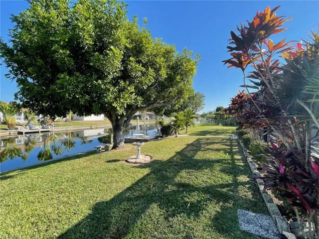 View of back yard featuring a water view