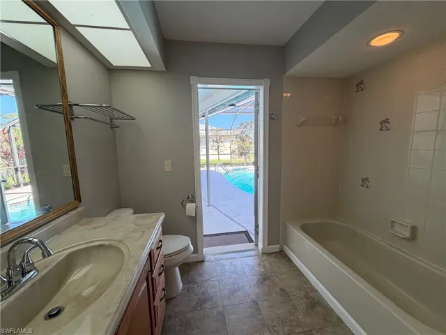 2nd Bathroom (pool bath) featuring vanity and shower / bath combination