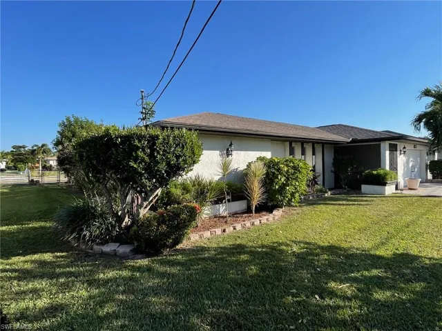 View of home's exterior featuring stucco siding and a lawn