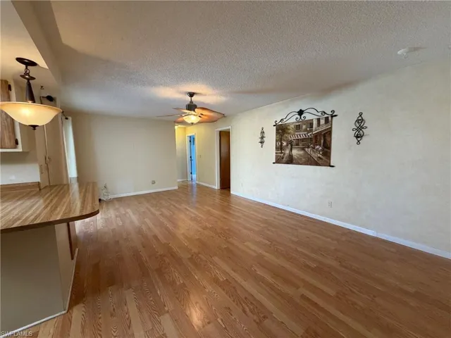 Living room with a view of pool and breakfast bar