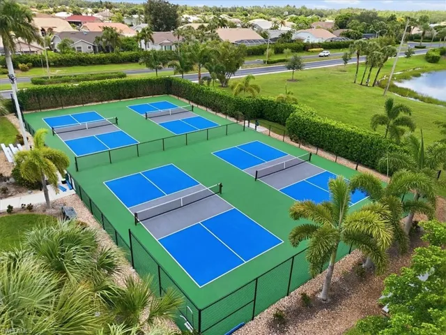 Four professional-grade pickleball courts featuring blue and gray playing surfaces