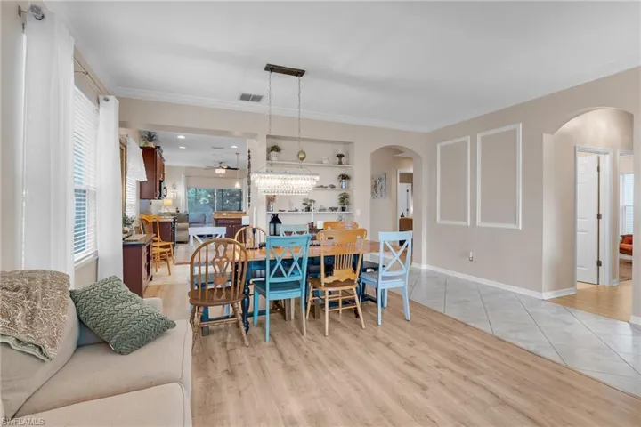 Dining room featuring built in shelves, ceiling fan, and light tile patterned flooring