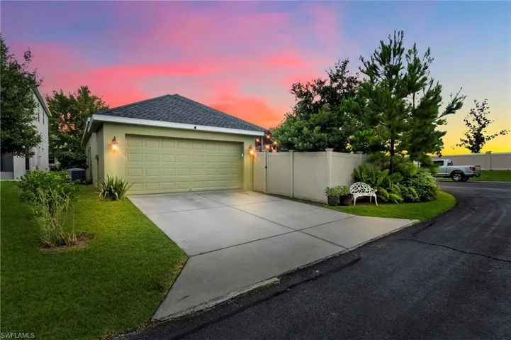 View of front of property with central AC and a lawn