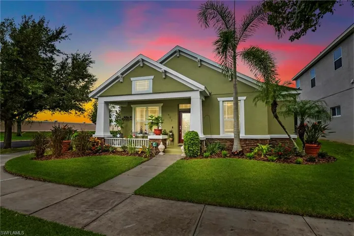 View of front of home with a lawn and covered porch