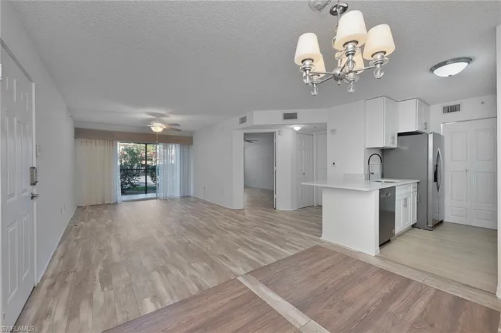 View of living room and kitchen from dining area.