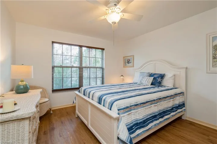 Bedroom featuring wood-type flooring and ceiling fan