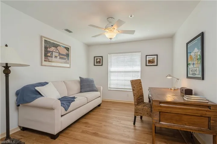 Office space with light hardwood / wood-style floors and ceiling fan