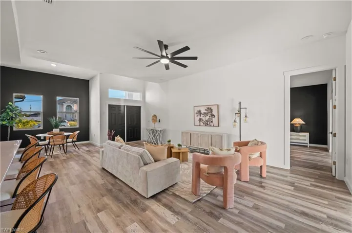 Living room featuring ceiling fan and light hardwood / wood-style flooring