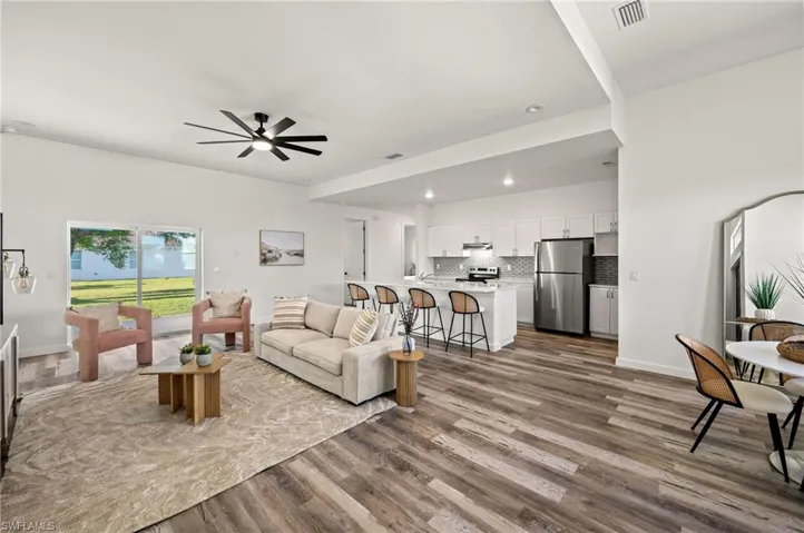 Living room featuring wood-type flooring and ceiling fan