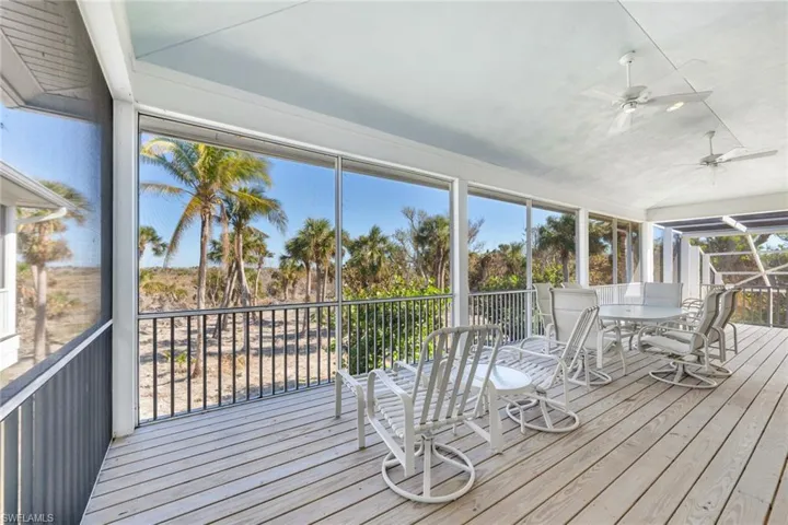 Unfurnished sunroom featuring ceiling fan