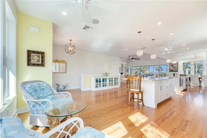 Kitchen with light hardwood / wood-style flooring, white cabinetry, and hanging light fixtures