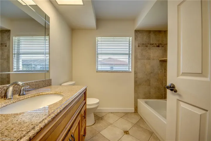 Secondary Bath with Tile Flooring & Tub Surround