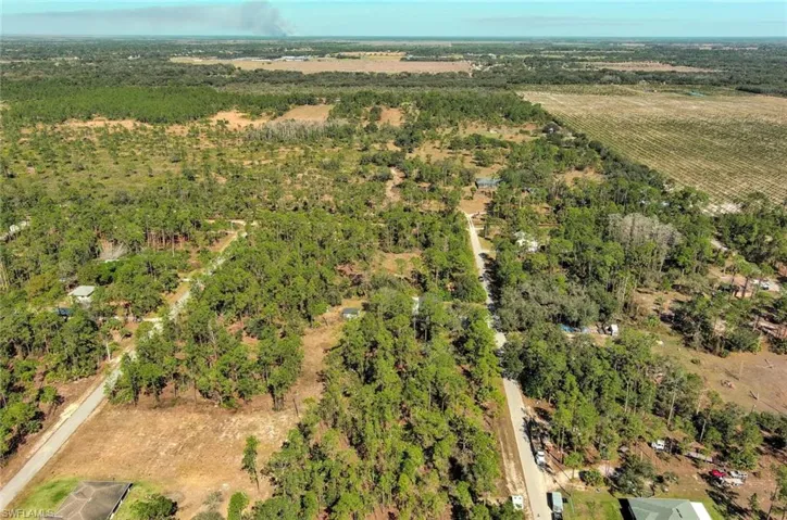 Aerial view of property's location featuring rural landscape and abundant farmland