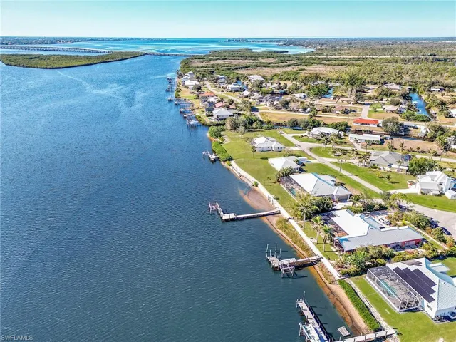 Birds eye view of property with a water view