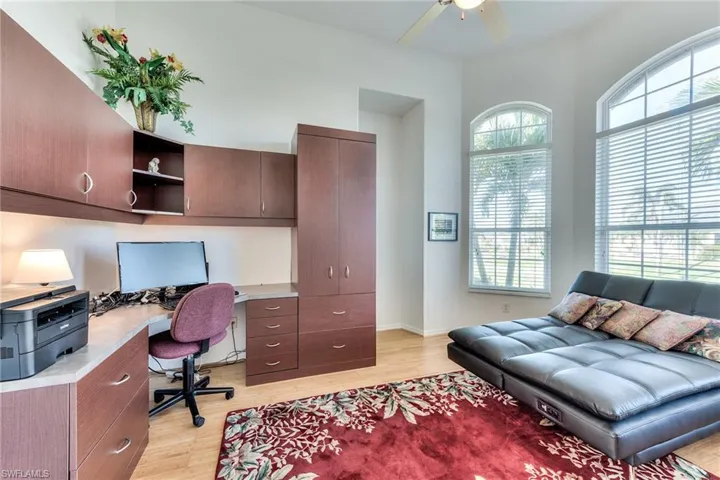 Office space with ceiling fan and light hardwood / wood-style flooring