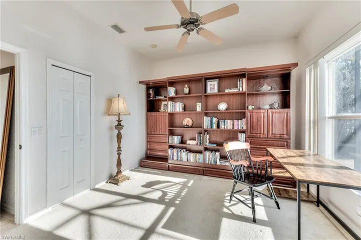 Carpeted office space with ceiling fan