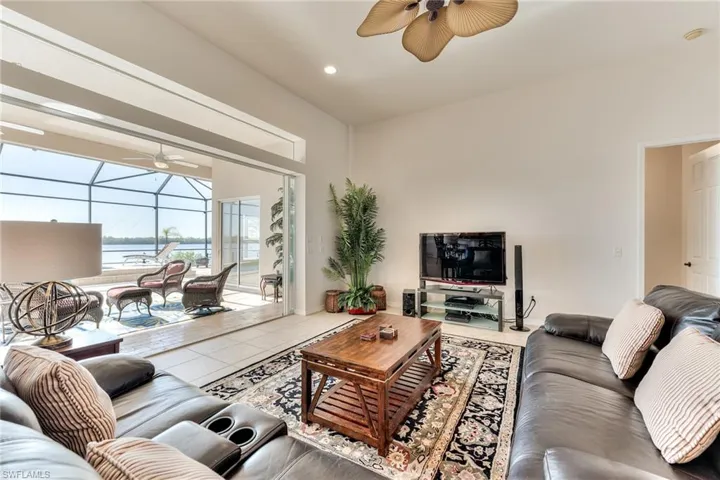 Living room featuring tile patterned flooring and a water view