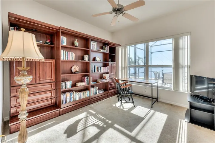 Carpeted office space with ceiling fan