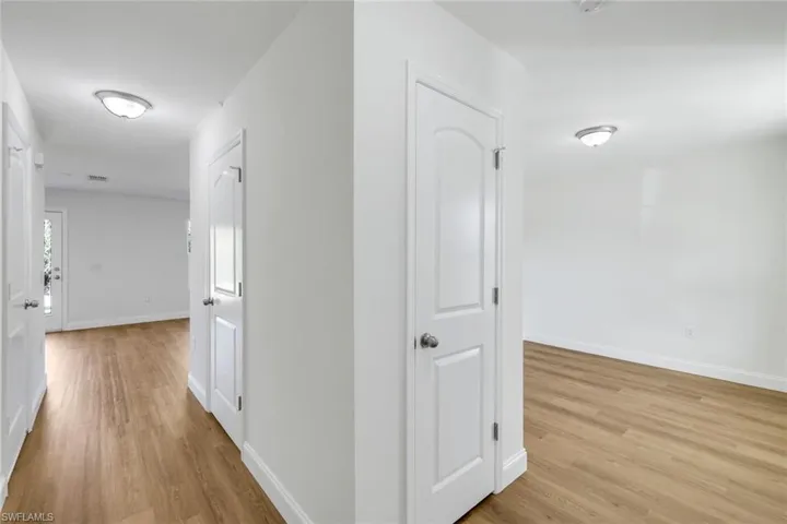 Corridor with light wood-type flooring