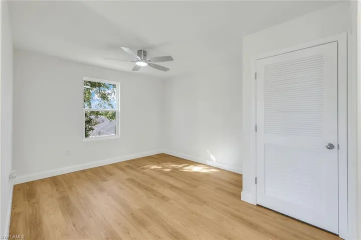 Spare room featuring ceiling fan and light wood-type flooring