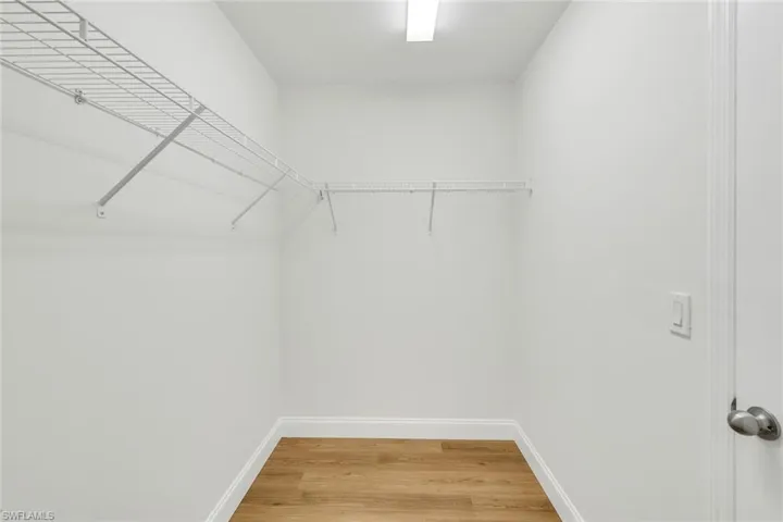 Spacious closet featuring hardwood / wood-style flooring