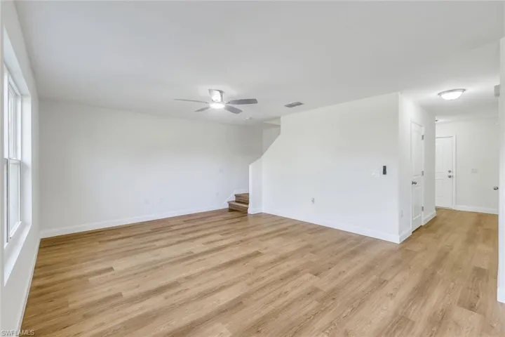 Empty room featuring plenty of natural light, ceiling fan, and light hardwood / wood-style flooring