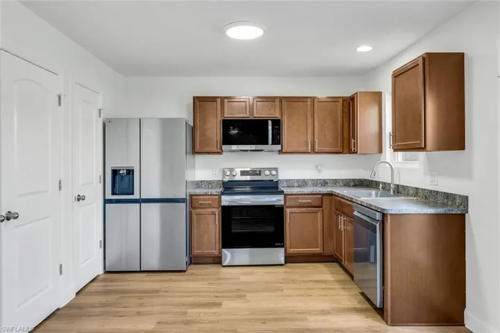 Kitchen featuring sink, stainless steel appliances, and light wood-type flooring