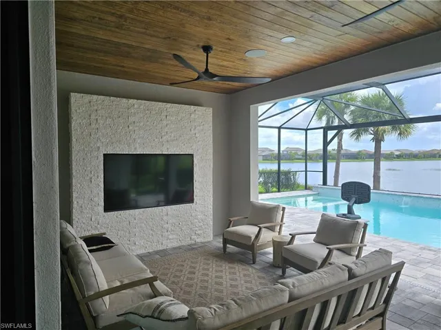 Custom wood tongue and grove ceiling with a stone feature tv wall built out and sonos speakers