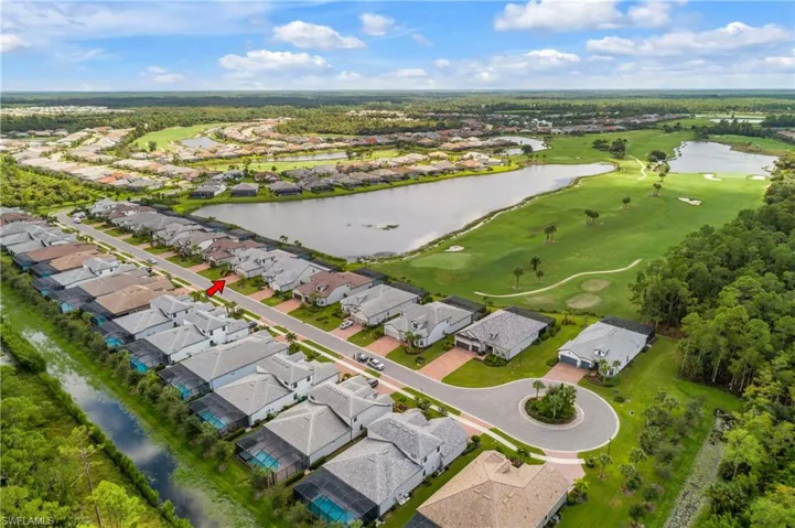 Bird's eye view with a water view, golf course and turn around quite street.