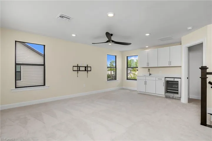 beverage area with sink and fridge in the loft