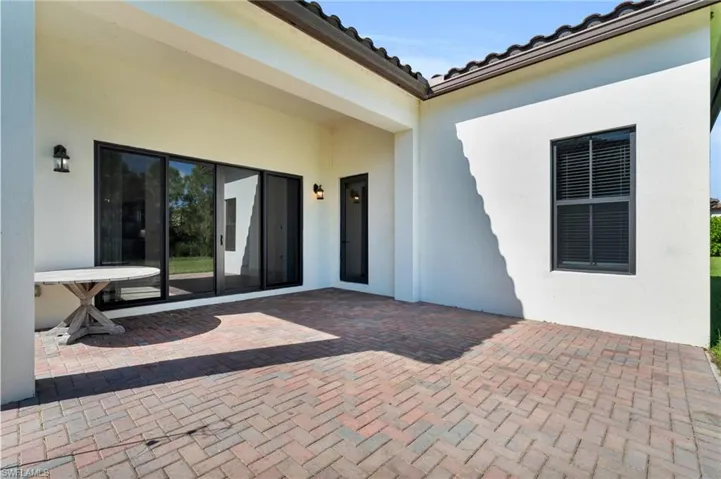 Property entrance with a patio