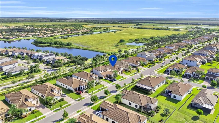 Birds eye view of property with a water view