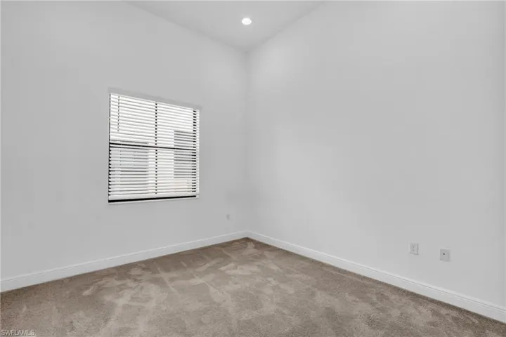 Spare room featuring light colored carpet