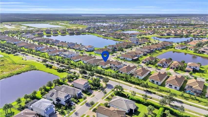 Birds eye view of property with a water view