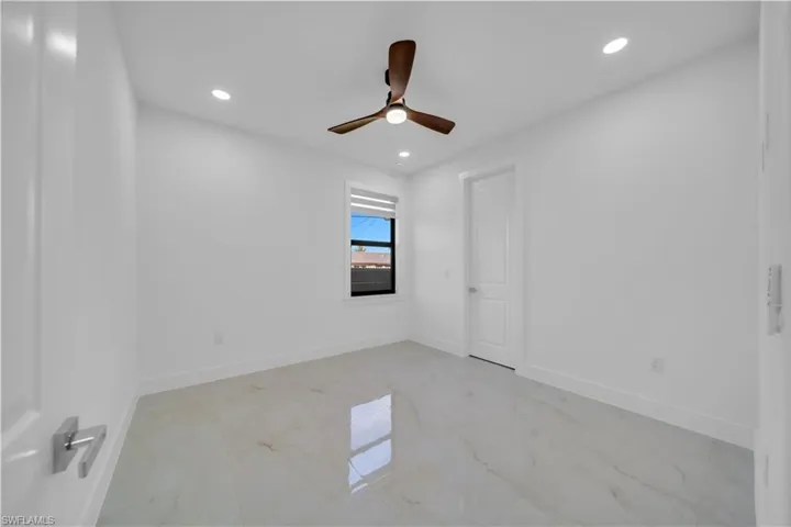 Spare room with recessed lighting, light marble finish flooring, and a ceiling fan