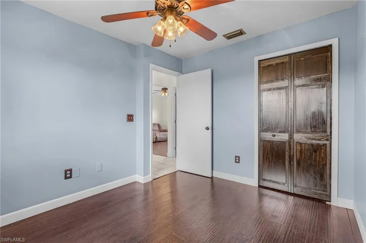 Unfurnished bedroom with a closet, ceiling fan, and hardwood / wood-style floors