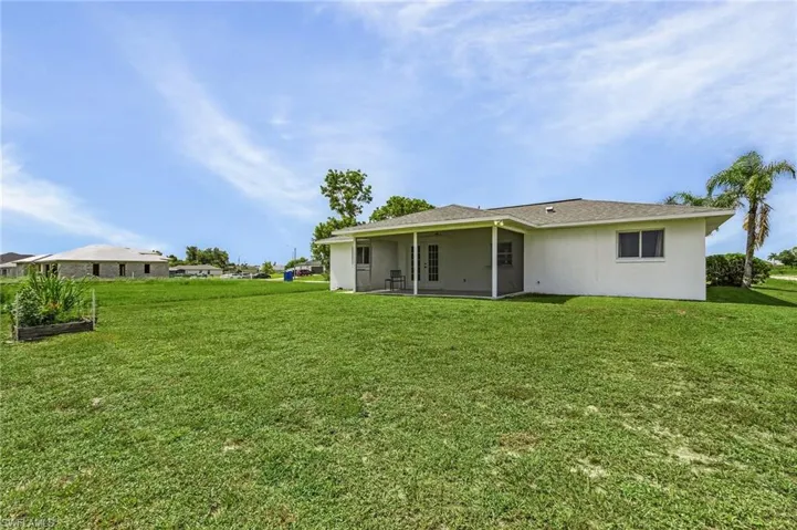 Back of property featuring a yard