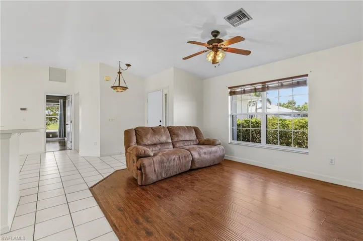 Living room featuring light wood-type flooring and ceiling fan
