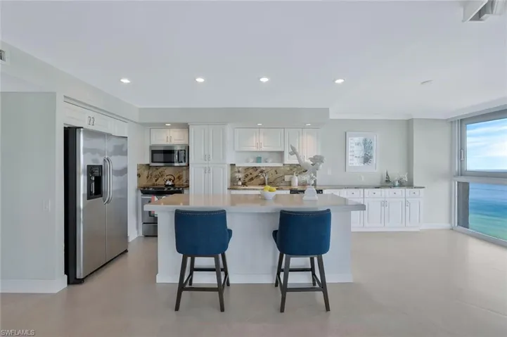 Kitchen with gorgeous Gulf views. Appliances with stainless steel finishes, white cabinets, center island with numerous pull out cupboards and drawers.