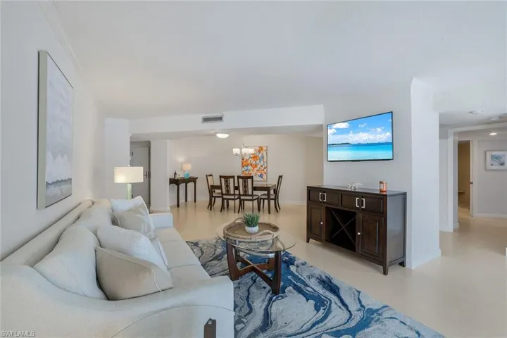Open plan showing living room and dining room. Back hall to the right showing entrance to Master Suite.