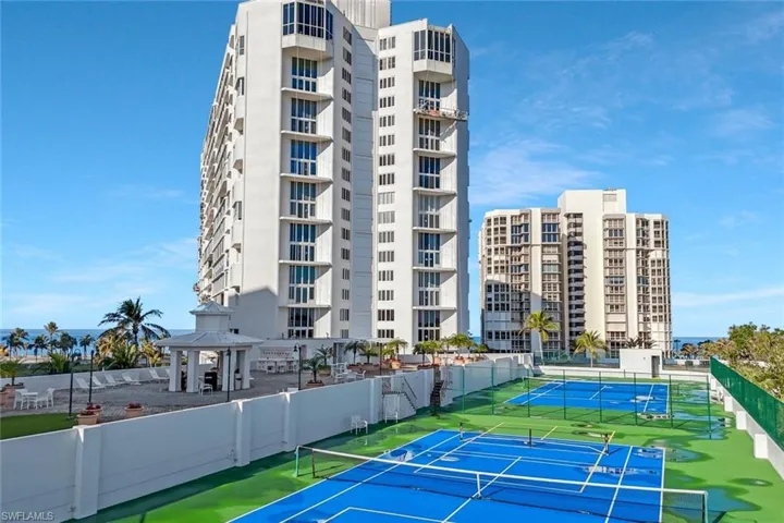 View of tennis/pickle ball courts, lounge area with grills, and putting green. This is the Recreation Deck accessed from the 2nd floor of the Savoy.