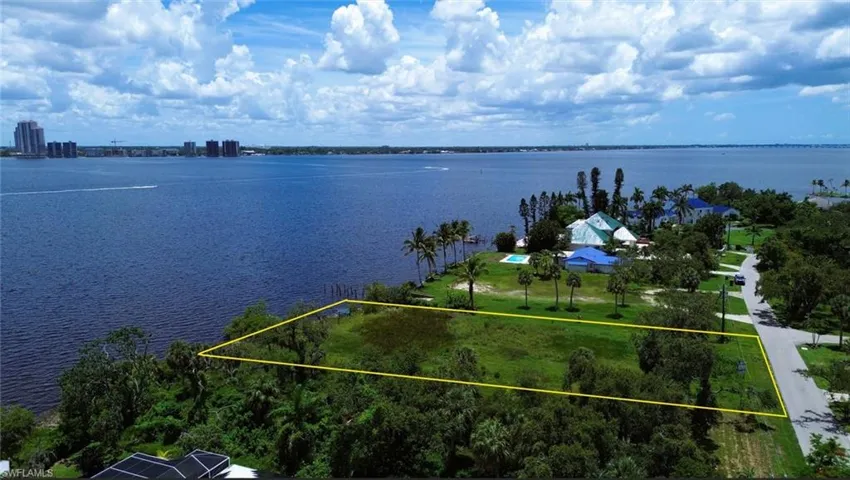 Aerial overview of property's location featuring a large body of water and property boundaries highlighted