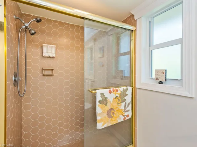 Full bath featuring tiled shower