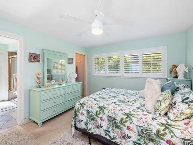 Bedroom featuring light colored carpet and a ceiling fan