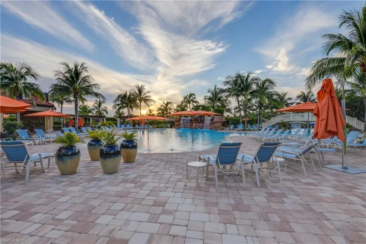 Pool at dusk with a community pool and a patio
