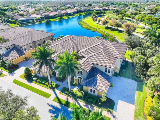 Aerial view of residential area featuring a nearby body of water