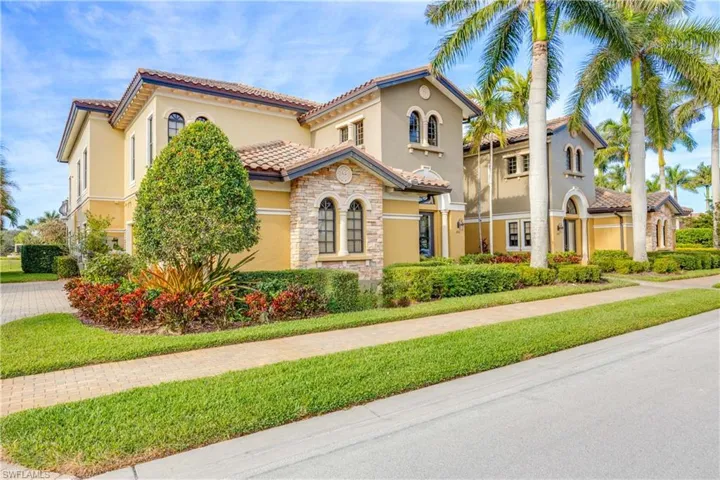 Mediterranean / spanish home with stucco siding, a tiled roof, and a front yard