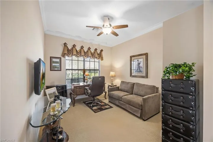 Office featuring carpet flooring, a ceiling fan, and ornamental molding