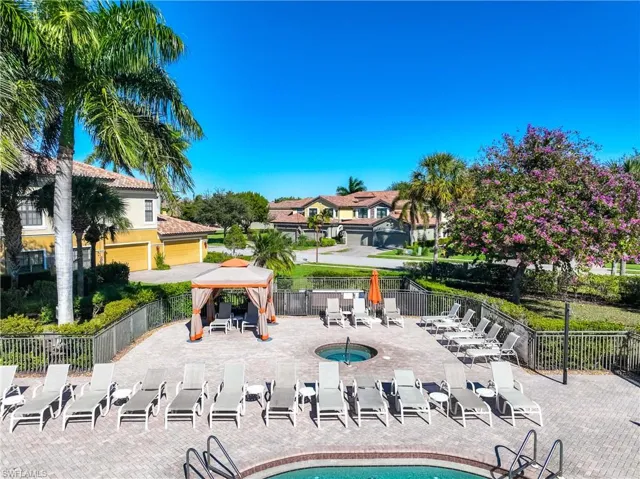 Community pool featuring a gazebo, a patio area, and a residential view