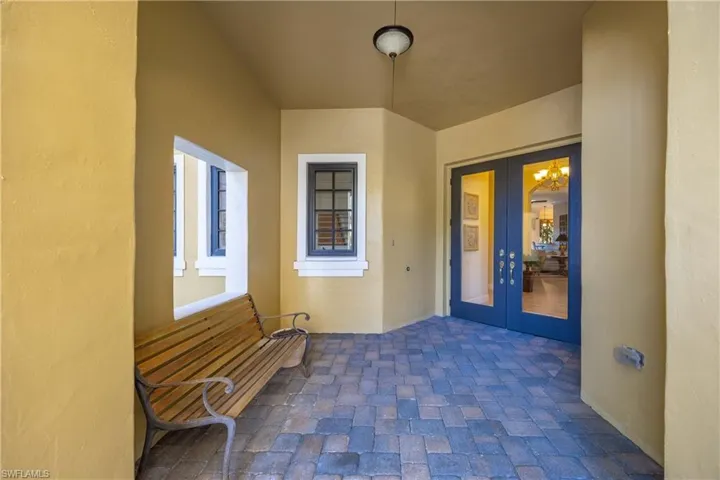 Doorway to property featuring french doors, stucco siding, and a patio area